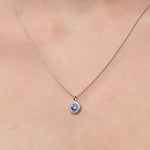 Lady wearing a Tanzanite & Diamond Pendant in 18ct White Gold