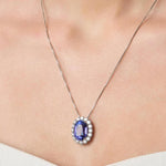 Necklace with a tanzanite pendant on a person wearing a white top