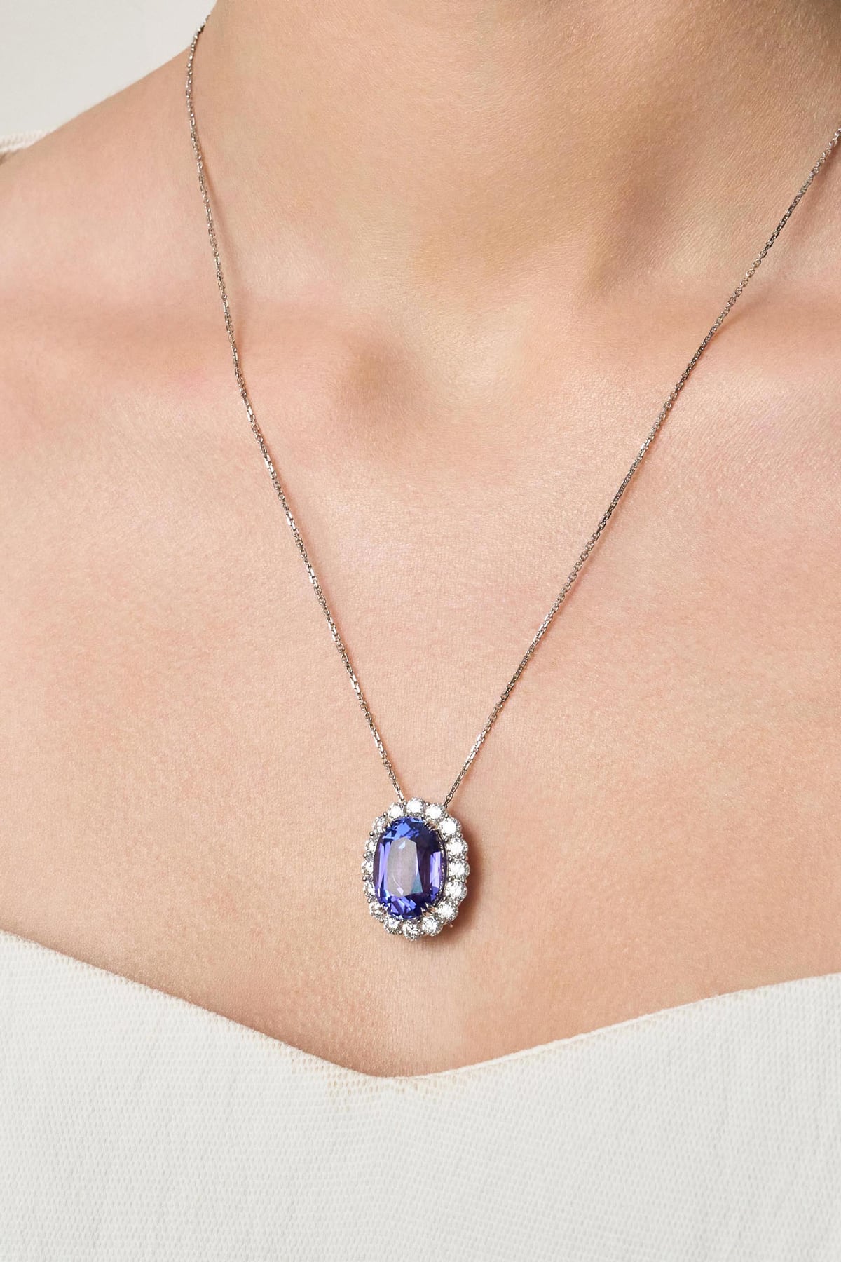 Necklace with a tanzanite pendant on a person wearing a white top