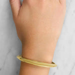 Lady wearing a 9ct Yellow Gold Cuff Style Bangle