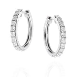 Pair of white gold hoop earrings with clear diamonds on a white background