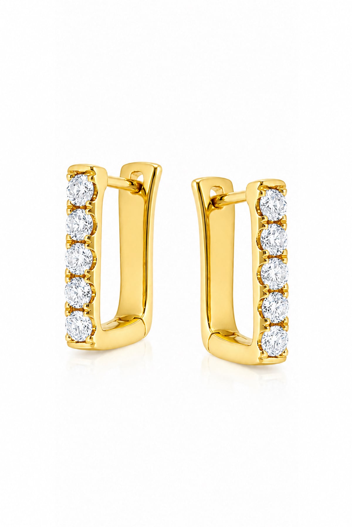 A pair of gold huggie hoop earrings with a vertical row of round-cut clear diamonds on the front, set against a plain white background.