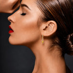 Lady wearing Citrine & Diamond Drop Earrings in Yellow Gold on a grey background