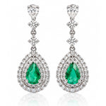 Pair of 18ct white gold Colombian emerald and diamond drop earrings featuring pear-shaped green emeralds surrounded by double halos of round brilliant-cut diamonds.