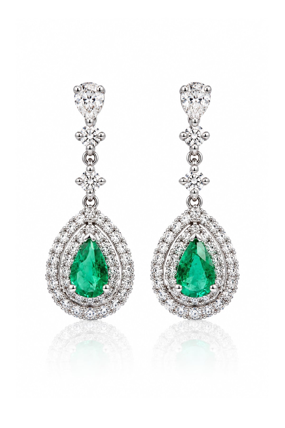 Pair of 18ct white gold Colombian emerald and diamond drop earrings featuring pear-shaped green emeralds surrounded by double halos of round brilliant-cut diamonds.