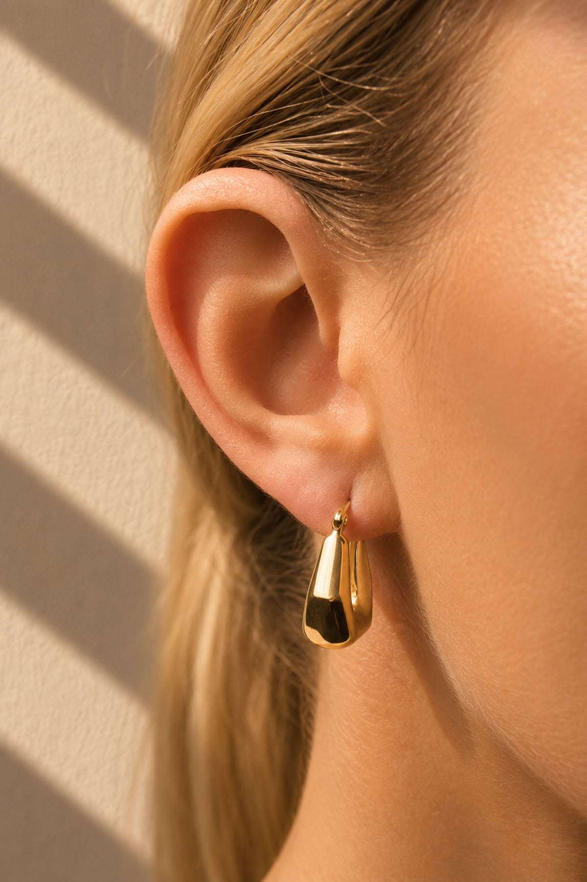Lady wearing Thick Semi-Hexagon Hoop Earrings in 9ct Yellow Gold