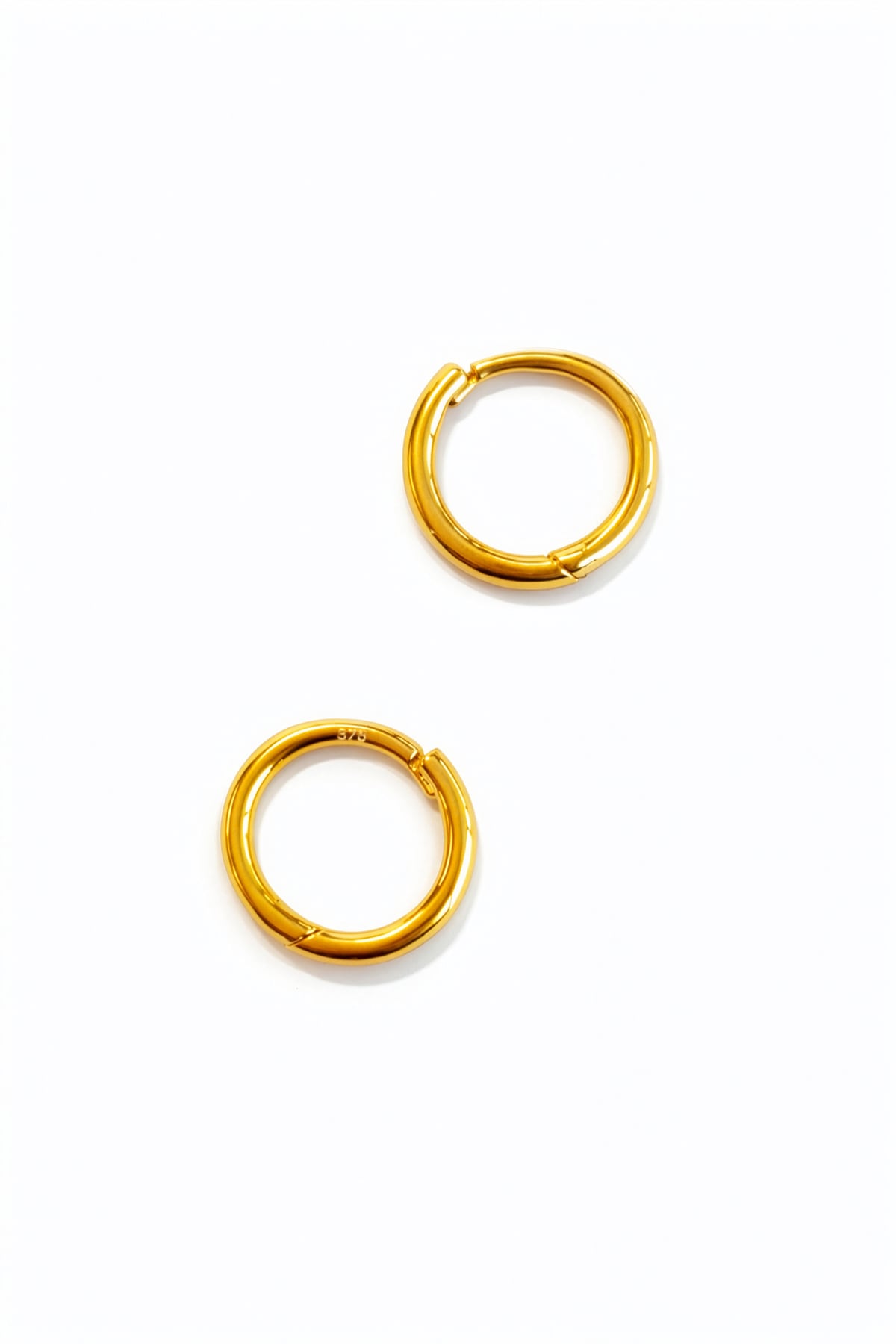 Pair of gold hoop earrings on a white background
