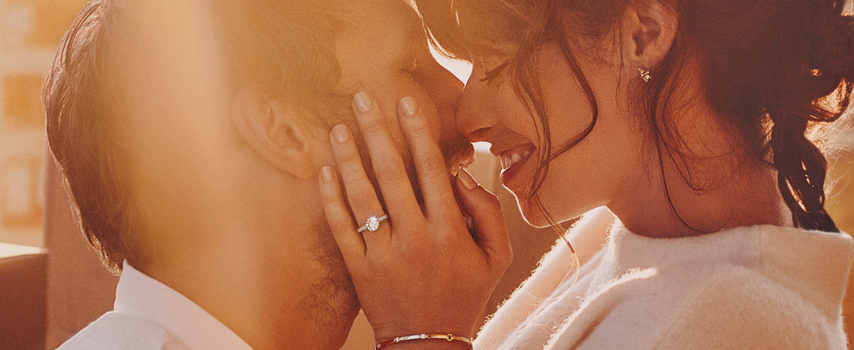 Lovers kissing wearing Hearts On Fire Jewellery.