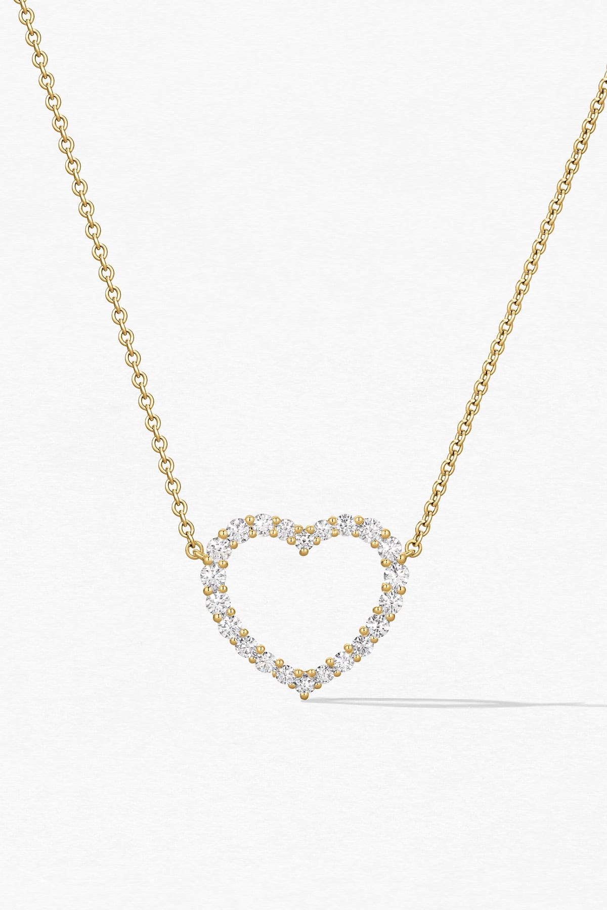 Heart-shaped diamond necklace on a white background