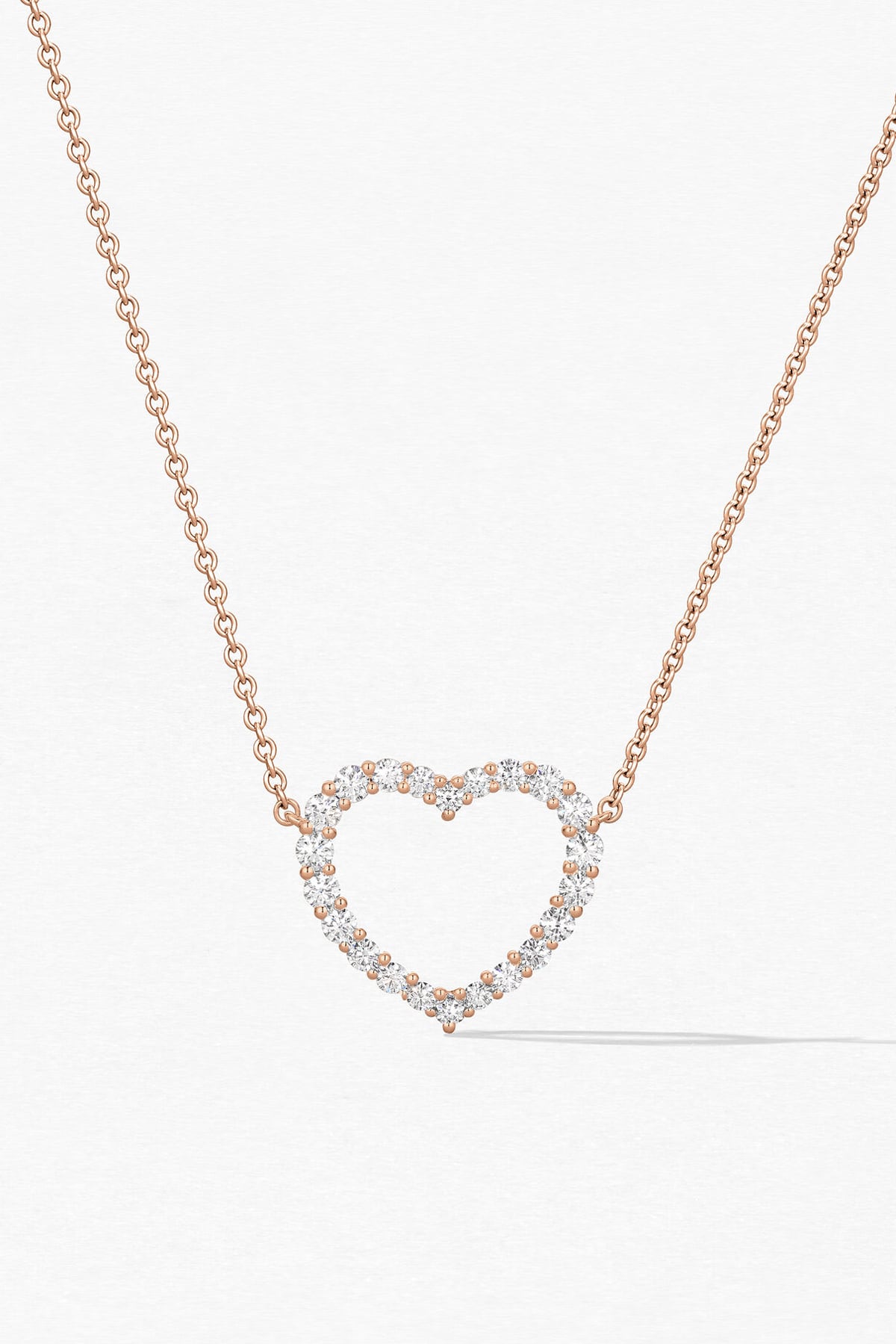 Heart-shaped diamond necklace on a white background