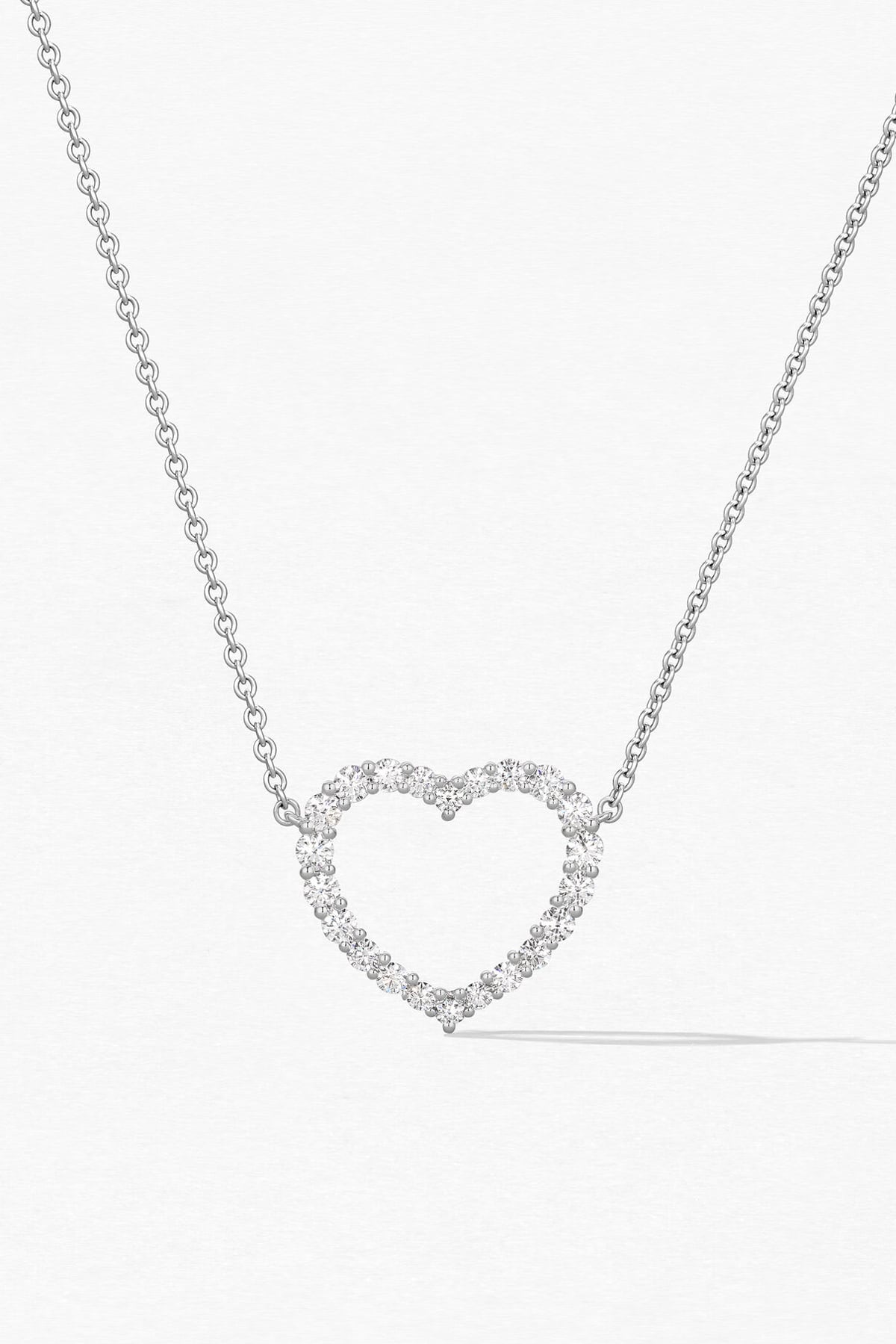Heart-shaped diamond necklace on a white background
