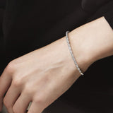 Silver bracelet on a wrist with a dark background