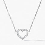 Heart-shaped diamond necklace on a white background
