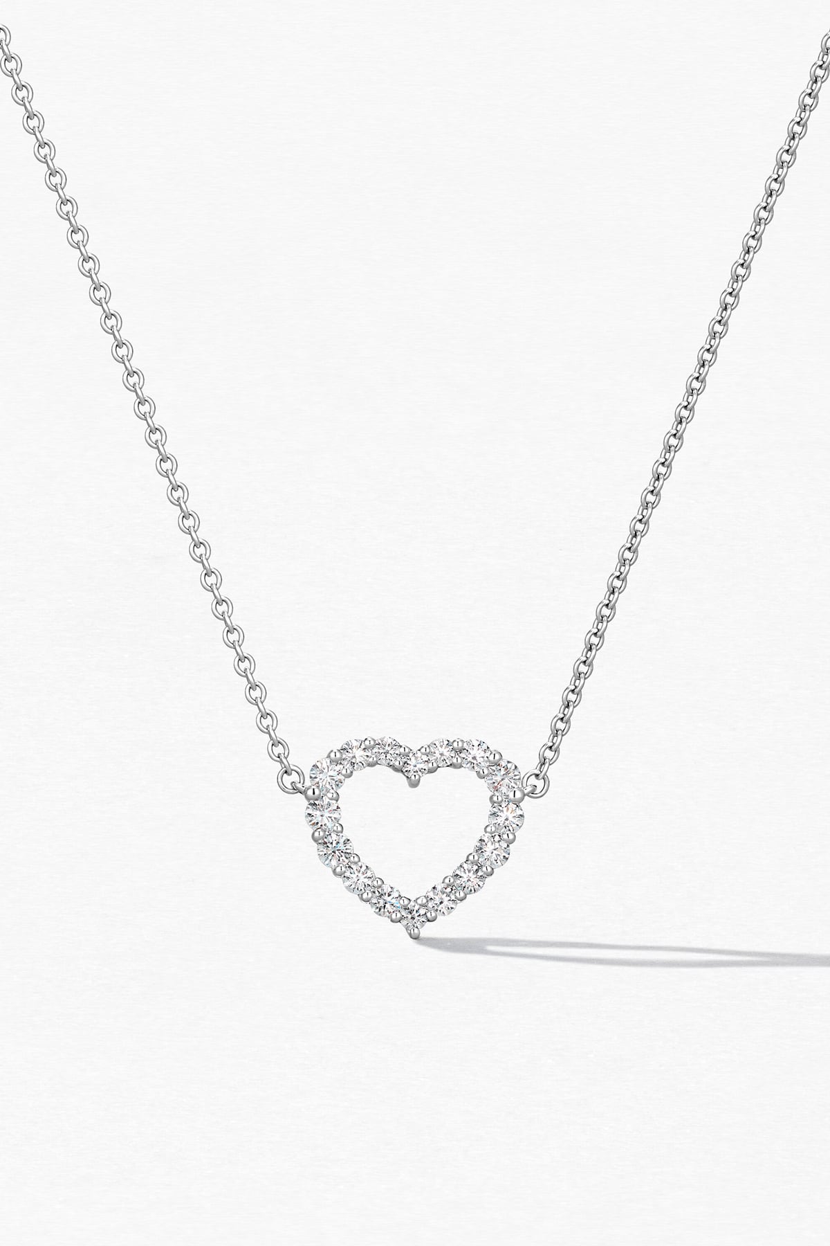 Heart-shaped diamond necklace on a white background