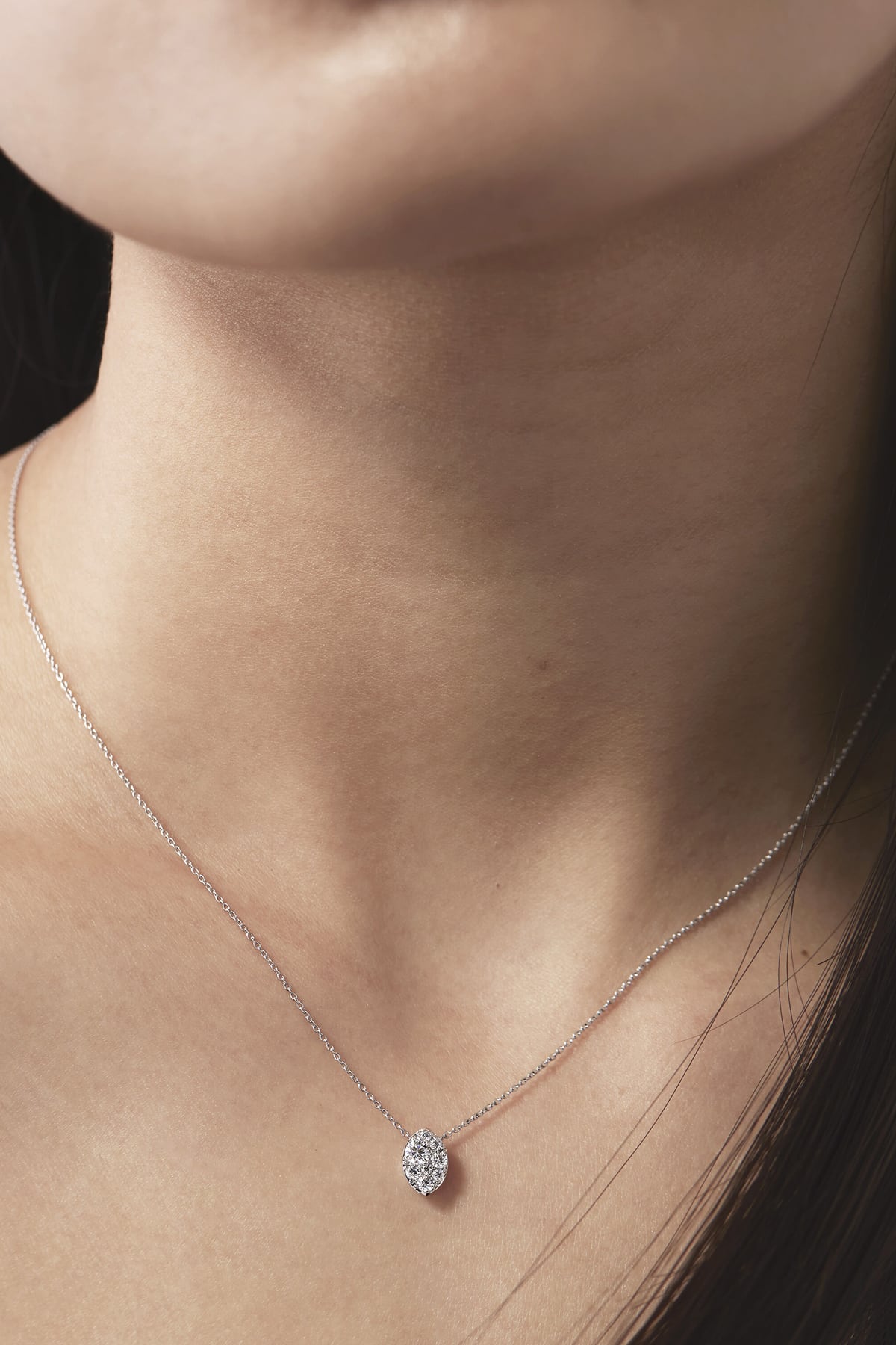 Close-up of a diamond necklace on a person's neck