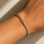 White Gold diamond bracelet on a wrist against a neutral background