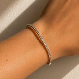 White Gold diamond bracelet on a wrist against a neutral background