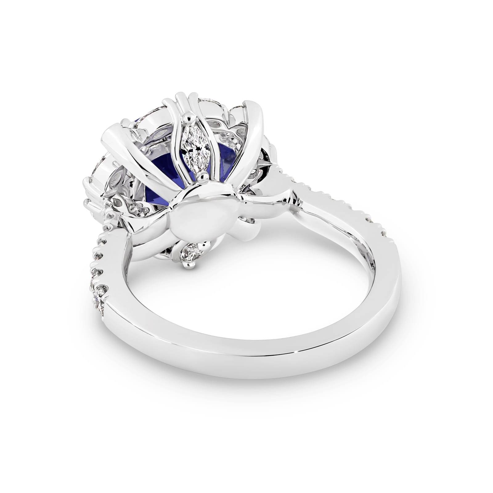 Violetta has a 4.06 carat cushion-cut tanzanite centre surrounded by a halo of alternating white round brilliant cut and marquise cut diamonds. Featuring 2 marquise cut diamonds underneath the ring and 14 round white diamonds on the band. She was designed and handcrafted by LeGassick's Master Jewellers, Gold Coast, Australia.