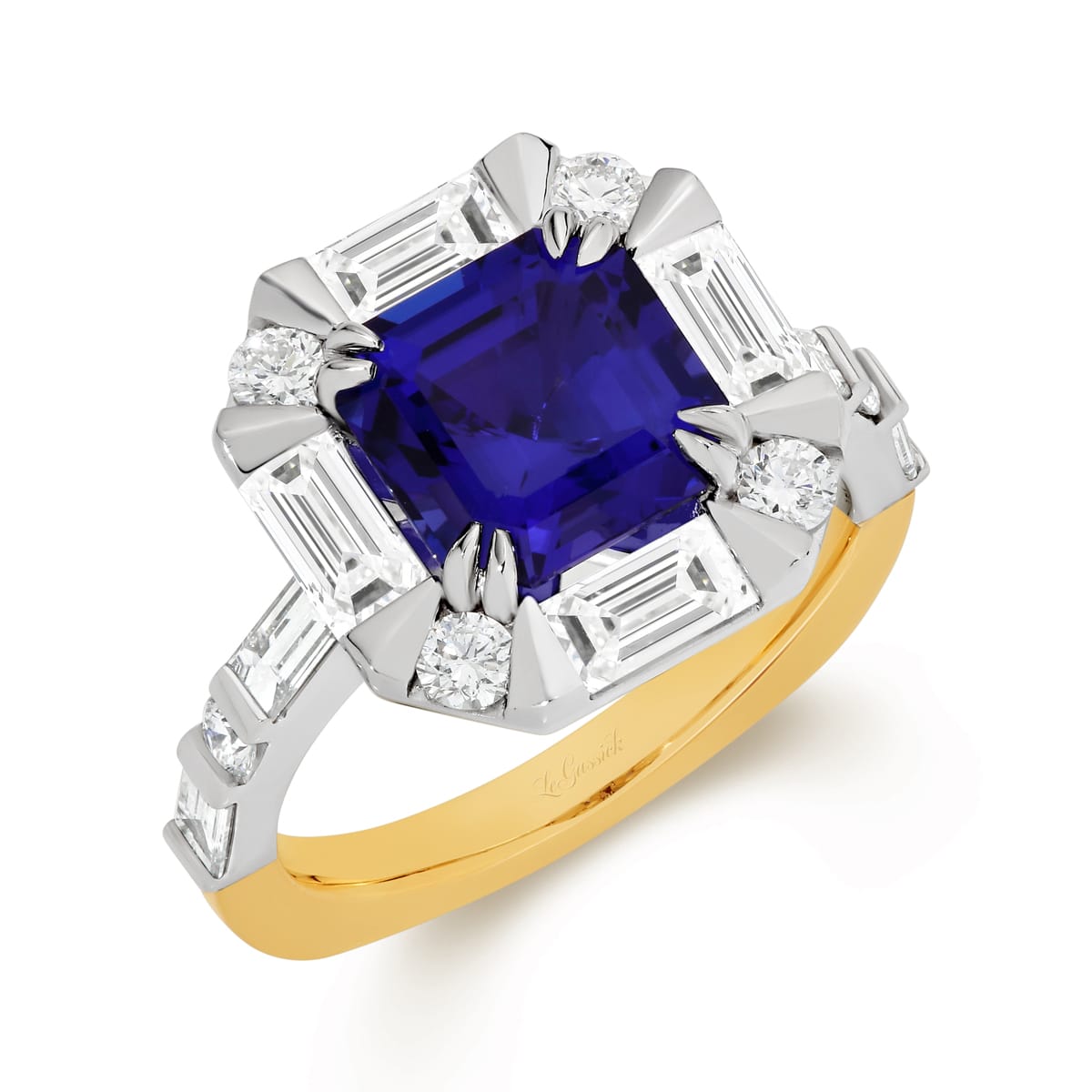 Zarriah features a 3.17ct Asscher cut tanzanite surrounded by a halo of baguette and round brilliant cut diamonds. Her centre stone is set in a double corner claws and her shoulders feature baguettes and round brilliant cut diamonds. Handcrafted to perfection in 18 carat yellow and white gold, she was designed and handcrafted by LeGassick's Master Jewellers, Gold Coast, Australia.