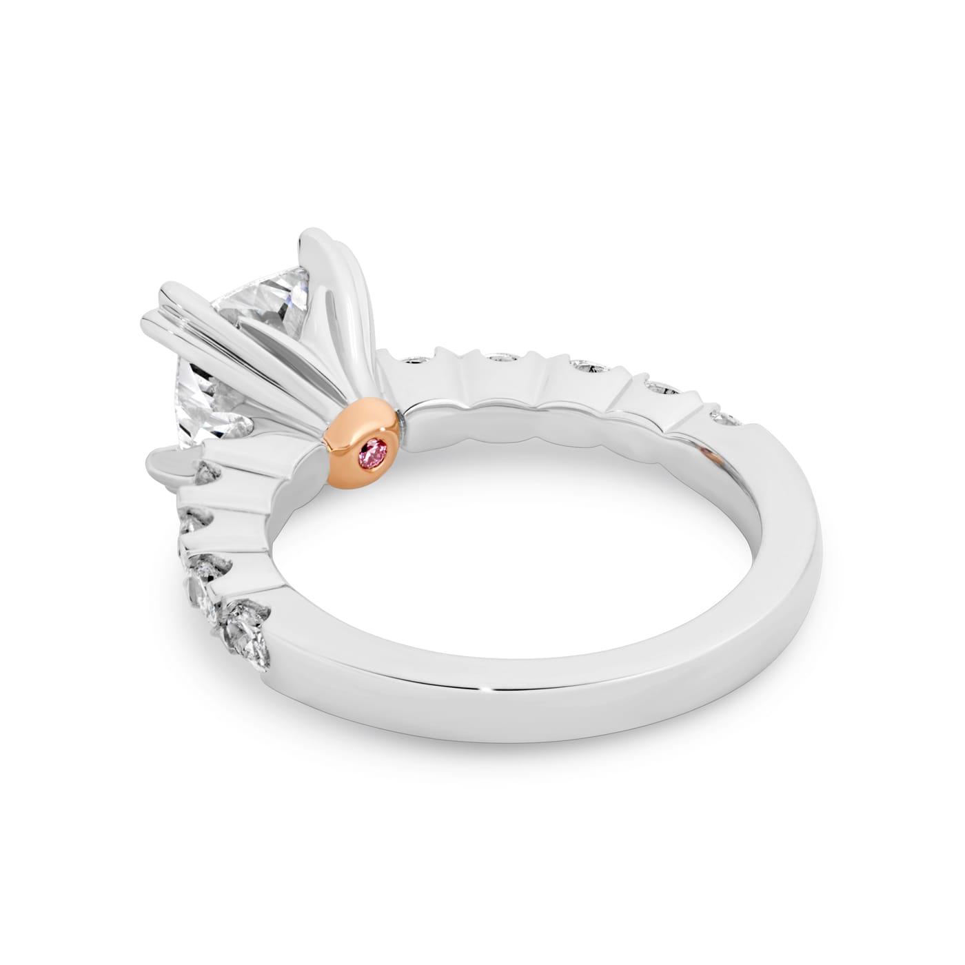 Grace has a 2.04 carat cushion-cut solitaire featuring 10 white oval cut diamonds on the band. Grace also features a natural Argyle pink diamond that has been nestled under her setting. She was designed and handcrafted by LeGassick's Master Jewellers, Gold Coast, Australia.