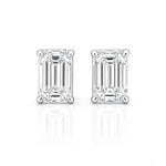 A pair of emerald-cut diamond stud earrings in a white gold setting, displayed on a clean white background with a soft reflection below.