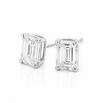 A pair of white gold stud earrings featuring rectangular emerald-cut clear diamonds in four-prong settings, shown on a clean white background.