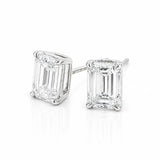 A pair of white gold stud earrings featuring rectangular emerald-cut clear diamonds in four-prong settings, shown on a clean white background.