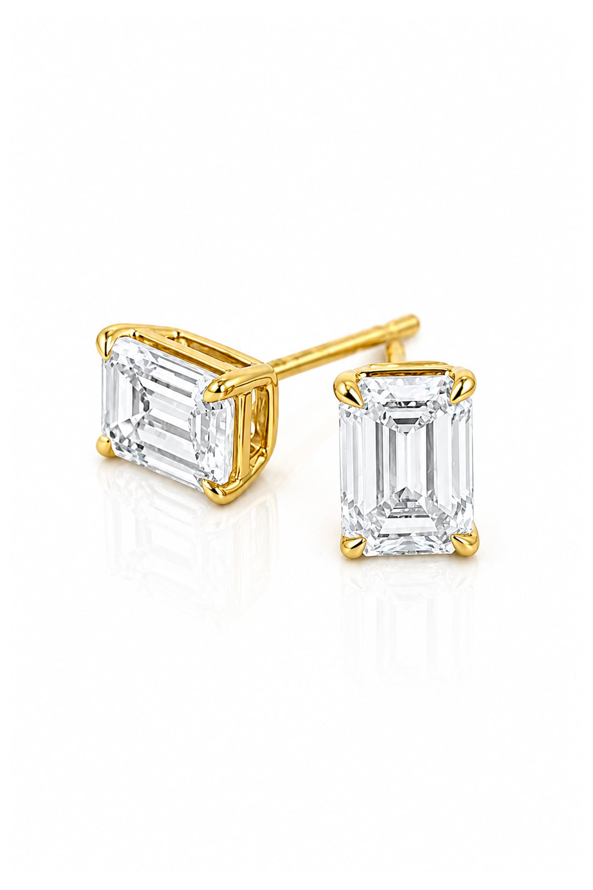 A pair of yellow gold stud earrings featuring rectangular emerald-cut clear diamonds in four-prong settings, shown on a clean white background.