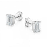 A pair of white gold stud earrings featuring rectangular emerald-cut clear diamonds in four-prong settings, shown on a clean white background.