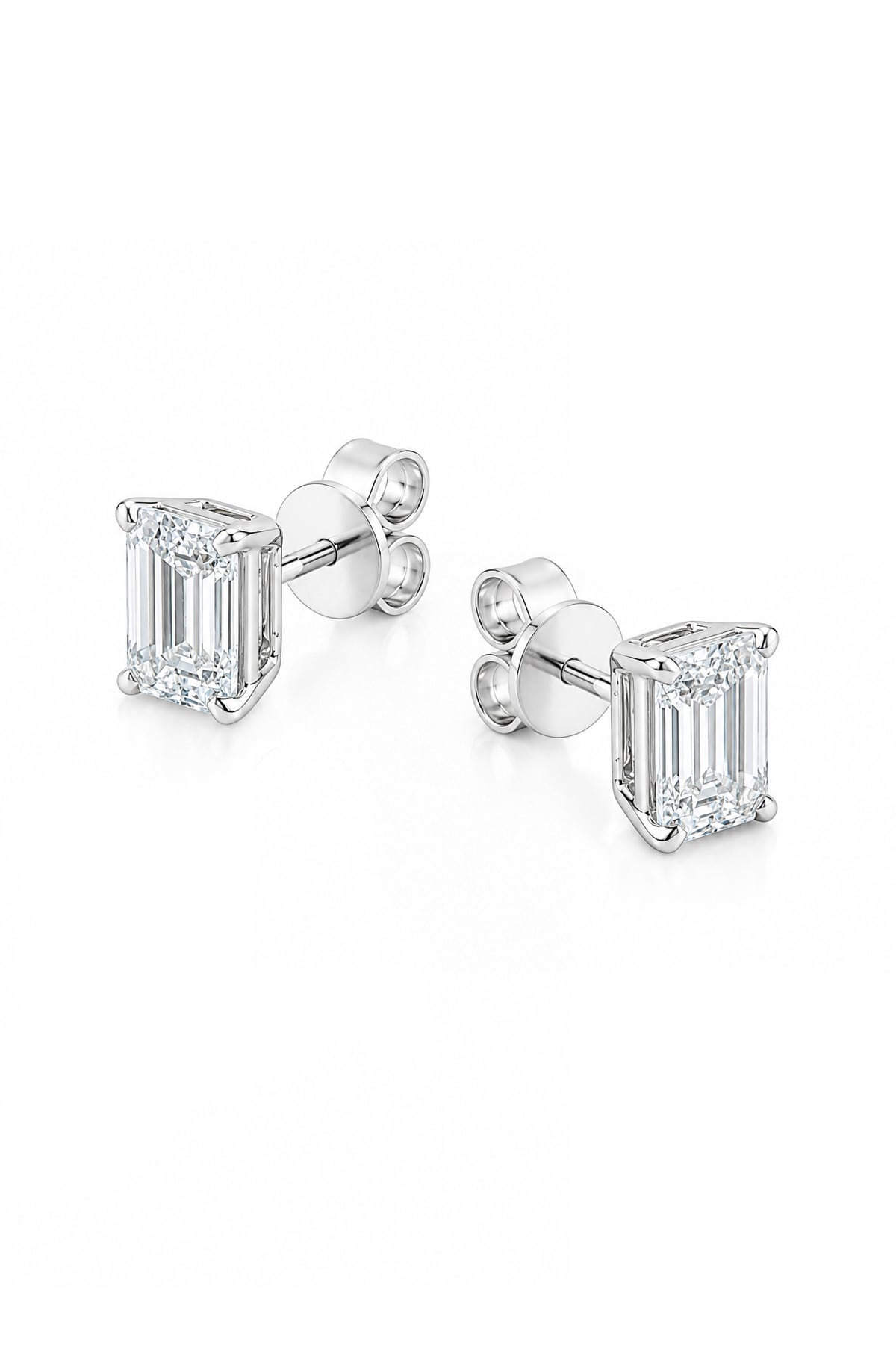 A pair of white gold stud earrings featuring rectangular emerald-cut clear diamonds in four-prong settings, shown on a clean white background.