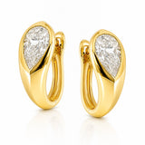 A pair of gold huggie hoop earrings with pear-cut diamond inlays, shown on a clean white background with a soft reflection.