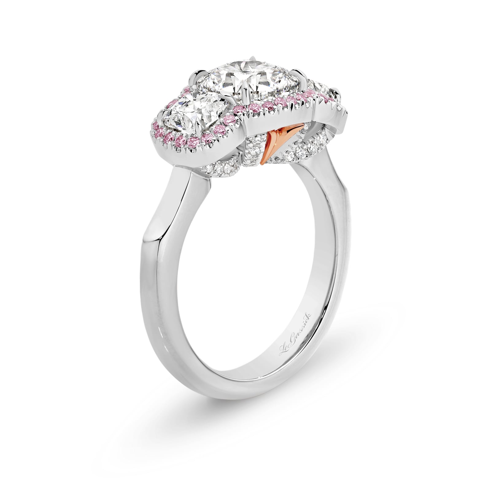 Melody features a trilogy of cushion-cut diamonds which includes a 2.11 carat centre stone with 2 x 0.50ct side stones that have been encircled by a halo of rare natural Argyle pink diamonds. Melody is delicately set with a further 40 round brilliant cut diamonds underneath the trilogy. She was designed and handcrafted by LeGassick's Master Jewellers, Gold Coast, Australia.