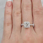Hand wearing a diamond ring on a neutral background at LeGassick.