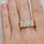 Gold ring with diamonds on a hand against a neutral background at LeGassick showroom