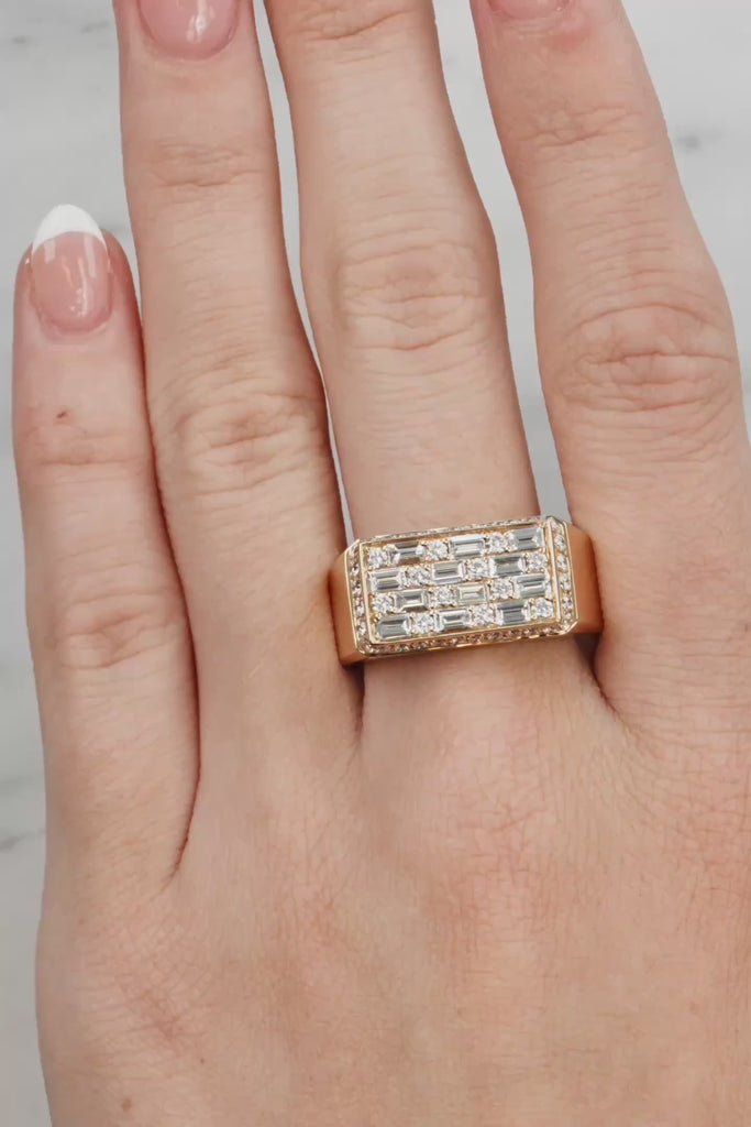 Gold ring with diamonds on a hand against a neutral background at LeGassick showroom