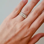 Hearts on fire gold ring with diamond stones on a light background