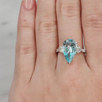 Lady's hand wearing a Pear Aquamarine & Diamond Ring set in 18ct White Gold at LeGassick.