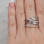 Hand wearing two silver rings with a light background at LeGassick