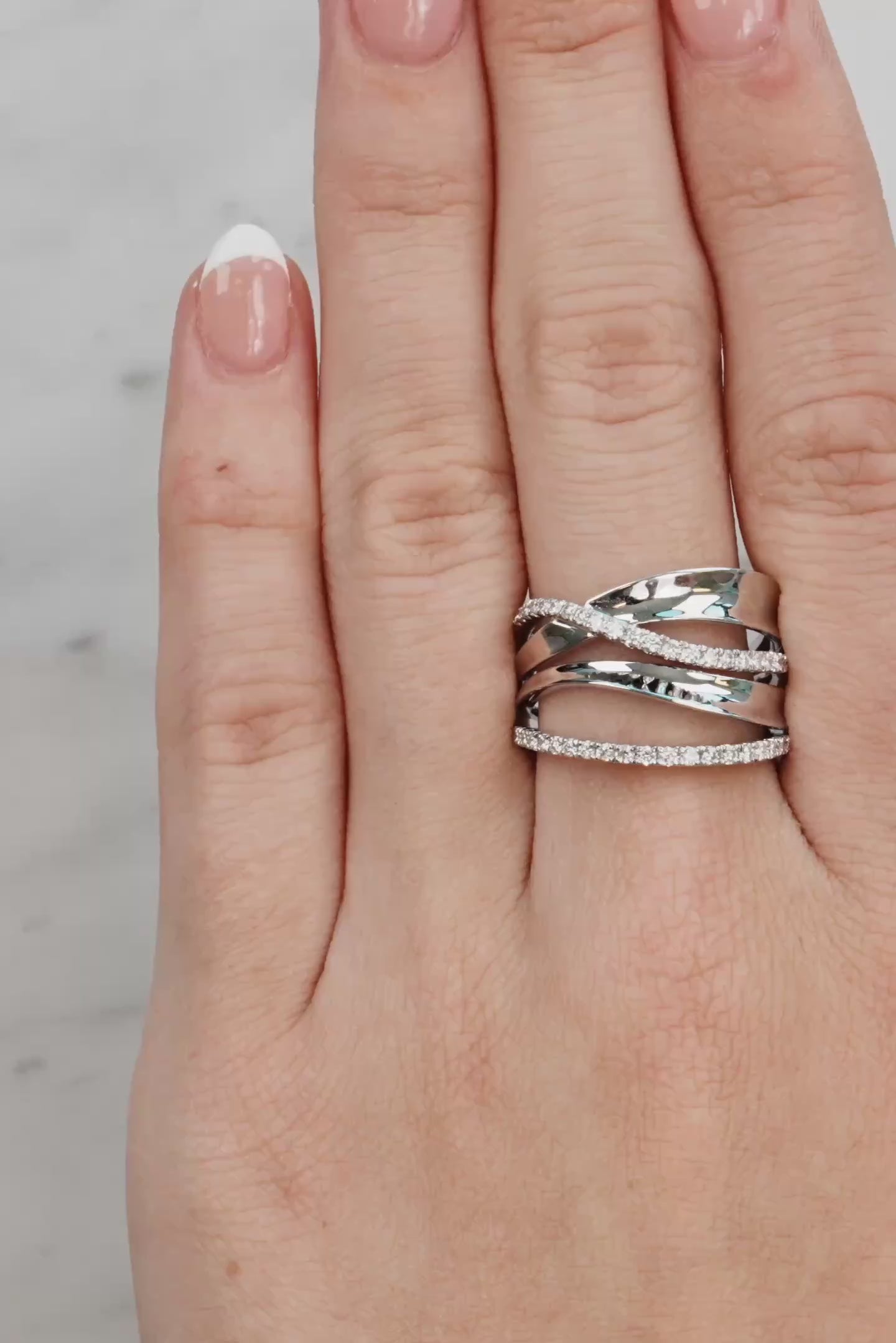 Hand wearing two silver rings with a light background at LeGassick