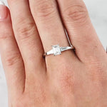 Lady wearing a Emerald Cut Diamond & Baguette Diamond Ring set in 18ct White Gold