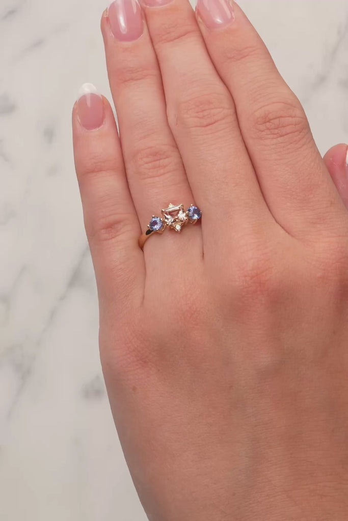 Morganite, Blue Sapphire & Diamond Dress Ring in 9ct Yellow Gold from LeGassick on a lady's finger.