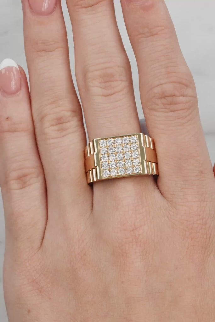 Gold ring with diamonds on a hand against a light background at LeGassick Showroom.