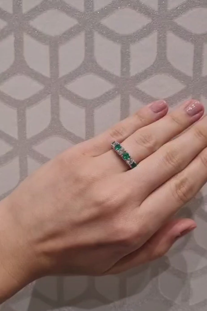 Emerald And Diamond Ring in 18 Carat Yellow And White Gold on lady's finger.