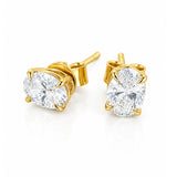 A pair of yellow gold stud earrings with round brilliant-cut clear diamonds in a four-prong setting, shown on a clean white background.