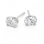 A pair of white gold stud earrings with round brilliant-cut clear diamonds in a four-prong setting, shown on a clean white background.
