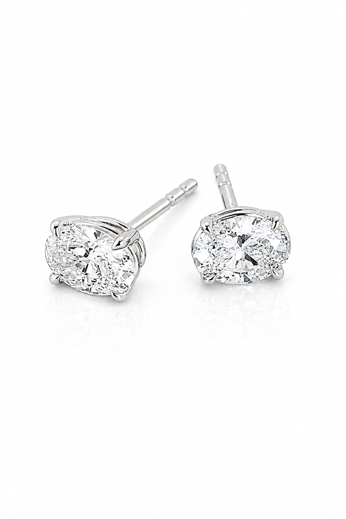 A pair of white gold stud earrings with round brilliant-cut clear diamonds in a four-prong setting, shown on a clean white background.
