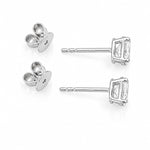 A pair of white gold stud earrings with oval clear diamonds and butterfly backings, displayed on a clean white background.