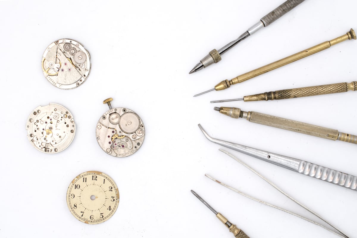 Watch parts and tools on a white background at LeGassick.