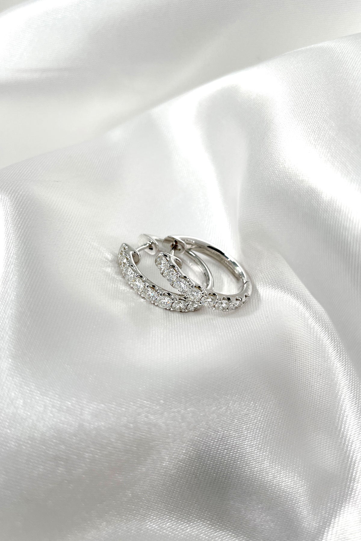 18 Carat White Gold Diamond Set Oval Huggie Earrings available at LeGassick Diamonds and Jewellery Gold Coast, Australia.